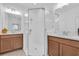 Modern bathroom with glass shower enclosure, double sinks, and wood cabinets offers a spa-like retreat at 2830 Dudley Ave, Odessa, FL 33556
