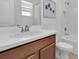 Clean bathroom showcasing a sink, toilet and bath-shower combination creates a functional and serene space at 2830 Dudley Ave, Odessa, FL 33556