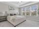 Bedroom with a large window, ceiling fan, plush carpet, a bed with a headboard and bedside tables with lamps at 2830 Dudley Ave, Odessa, FL 33556