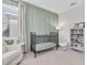 Cozy Bedroom with a crib, plush chair, bookshelf and decor that creates a nurturing and inviting space at 2830 Dudley Ave, Odessa, FL 33556