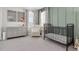 Charming Bedroom featuring a crib, dresser, chair and decor that creates a warm and inviting space at 2830 Dudley Ave, Odessa, FL 33556