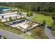 Aerial view of the fenced community garden featuring raised planting beds, tool shed, and quaint windmill at 2830 Dudley Ave, Odessa, FL 33556