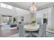 Open concept living area with a dining area featuring a chandelier, opening to the living room and outdoor patio at 2830 Dudley Ave, Odessa, FL 33556