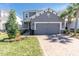 Charming two-story home with well-manicured lawn, paved driveway and a two-car garage at 2830 Dudley Ave, Odessa, FL 33556