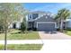 Two-story house with a well-maintained lawn, brick driveway and a two-car garage at 2830 Dudley Ave, Odessa, FL 33556