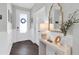 Bright foyer with wainscoting, dark wood floors, and decorative mirror at 2830 Dudley Ave, Odessa, FL 33556