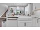 Open concept kitchen with granite countertops, a stainless steel sink, and views to the living and dining areas at 2830 Dudley Ave, Odessa, FL 33556
