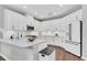 Modern kitchen featuring white cabinets, stainless steel appliances, a large island, and hardwood flooring at 2830 Dudley Ave, Odessa, FL 33556