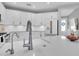 Beautiful white kitchen with stainless steel appliances, bright lighting, and a large granite countertop at 2830 Dudley Ave, Odessa, FL 33556