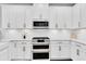 Kitchen featuring white cabinetry, stainless steel appliances, subway tile backsplash, and granite countertops at 2830 Dudley Ave, Odessa, FL 33556