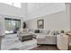 Spacious living room featuring soaring ceilings and sliding glass doors to the pool at 2830 Dudley Ave, Odessa, FL 33556