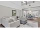 Open-concept living room with a view to the kitchen, dining area, and second-story at 2830 Dudley Ave, Odessa, FL 33556
