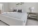 Primary bedroom with a bed, bedside tables, lamps, and neutral wall paint at 2830 Dudley Ave, Odessa, FL 33556