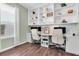 Home office featuring built-in shelves, two desks with office chairs, and neutral wall paint at 2830 Dudley Ave, Odessa, FL 33556