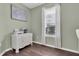 Bright home office with a white dresser, a large window with blinds, and light green wall paint at 2830 Dudley Ave, Odessa, FL 33556