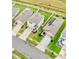 Aerial view of modern homes with well-kept lawns in a residential neighborhood with landscaped yards at 30845 Penny Surf Loop, Wesley Chapel, FL 33545