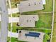 Aerial view of a neighborhood showcasing the roof, driveway and landscaping at 30845 Penny Surf Loop, Wesley Chapel, FL 33545