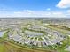 Panoramic aerial of a community with a central pond and lush green spaces at 30845 Penny Surf Loop, Wesley Chapel, FL 33545