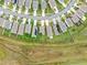 Aerial view of single-Gathering homes with solar panels in a planned community featuring well-maintained lawns at 30845 Penny Surf Loop, Wesley Chapel, FL 33545