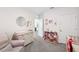 Bright Bedroom with changing table, pink bookshelf, and light gray carpet at 30845 Penny Surf Loop, Wesley Chapel, FL 33545