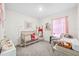 Charming Bedroom with a crib, rocking chair, and soft decor elements at 30845 Penny Surf Loop, Wesley Chapel, FL 33545