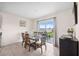 Bright dining room with glass-top table and chairs, and a view of the backyard at 30845 Penny Surf Loop, Wesley Chapel, FL 33545
