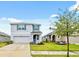 Daytime view of a well-maintained two-story home with a green lawn and neat landscaping at 30845 Penny Surf Loop, Wesley Chapel, FL 33545