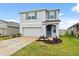 A beautiful home showcases curb appeal with its manicured lawn and attached two-car garage at 30845 Penny Surf Loop, Wesley Chapel, FL 33545