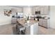 Bright kitchen featuring granite countertops, stainless appliances, an island, and grey cabinets at 30845 Penny Surf Loop, Wesley Chapel, FL 33545