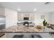 Modern kitchen boasts a large island with granite countertops and stainless steel appliances at 30845 Penny Surf Loop, Wesley Chapel, FL 33545