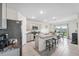 Modern kitchen features a center island with seating, granite countertops, and stainless steel appliances at 30845 Penny Surf Loop, Wesley Chapel, FL 33545