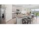 Open kitchen featuring a large island, stainless steel appliances, and a view to the backyard at 30845 Penny Surf Loop, Wesley Chapel, FL 33545