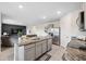 Kitchen area featuring an island with a sink, stainless steel appliances, and open floorplan at 30845 Penny Surf Loop, Wesley Chapel, FL 33545
