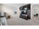 Comfortable living area with entertainment center and a wall-mounted large screen television at 30845 Penny Surf Loop, Wesley Chapel, FL 33545