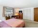 Bedroom with a light pink comforter, a desk, and plenty of natural light at 3632 Pensdale Dr, New Port Richey, FL 34652