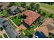 Aerial view of a house with tile roof, mature landscaping, and brick driveway at 370 Tall Oak Trl, Tarpon Springs, FL 34688