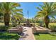 This beautifully landscaped backyard features a brick patio with outdoor fireplace and seating at 370 Tall Oak Trl, Tarpon Springs, FL 34688