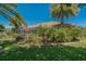This home boasts an outdoor oasis with lush, verdant landscaping surrounding the screened-in patio at 370 Tall Oak Trl, Tarpon Springs, FL 34688