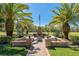 This beautifully landscaped backyard features a brick patio with outdoor fireplace and seating at 370 Tall Oak Trl, Tarpon Springs, FL 34688
