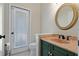 Bright bathroom with unique sink and fixtures, round mirror and bright light at 370 Tall Oak Trl, Tarpon Springs, FL 34688