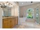Elegant bathroom featuring a soaking tub, walk-in shower, and large vanity with double sinks at 370 Tall Oak Trl, Tarpon Springs, FL 34688