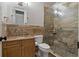 Well-appointed bathroom featuring a granite countertop vanity and a modern glass shower with tile surround at 370 Tall Oak Trl, Tarpon Springs, FL 34688