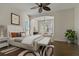 Cozy bedroom featuring a bay window nook, ceiling fan, and an ensuite bath at 370 Tall Oak Trl, Tarpon Springs, FL 34688