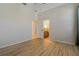 Neutral bedroom with wood-look floors and open doorway to bathroom at 370 Tall Oak Trl, Tarpon Springs, FL 34688