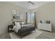 Cozy bedroom with metal bed frame, white dresser, and windows offering plenty of natural light at 370 Tall Oak Trl, Tarpon Springs, FL 34688