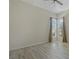 Bright, empty bedroom featuring hardwood floors and windows with natural light; ready for personal touches at 370 Tall Oak Trl, Tarpon Springs, FL 34688