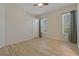 Bright bedroom features wood-look flooring, natural light from two windows and a ceiling fan at 370 Tall Oak Trl, Tarpon Springs, FL 34688