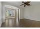 Bright bonus room featuring a bay window nook, a ceiling fan, and patio access at 370 Tall Oak Trl, Tarpon Springs, FL 34688