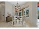 Bright dining area features a stylish chandelier and large windows with a view to the patio at 370 Tall Oak Trl, Tarpon Springs, FL 34688