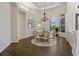 Bright dining room features wood floors, a chandelier and large windows offering natural light at 370 Tall Oak Trl, Tarpon Springs, FL 34688